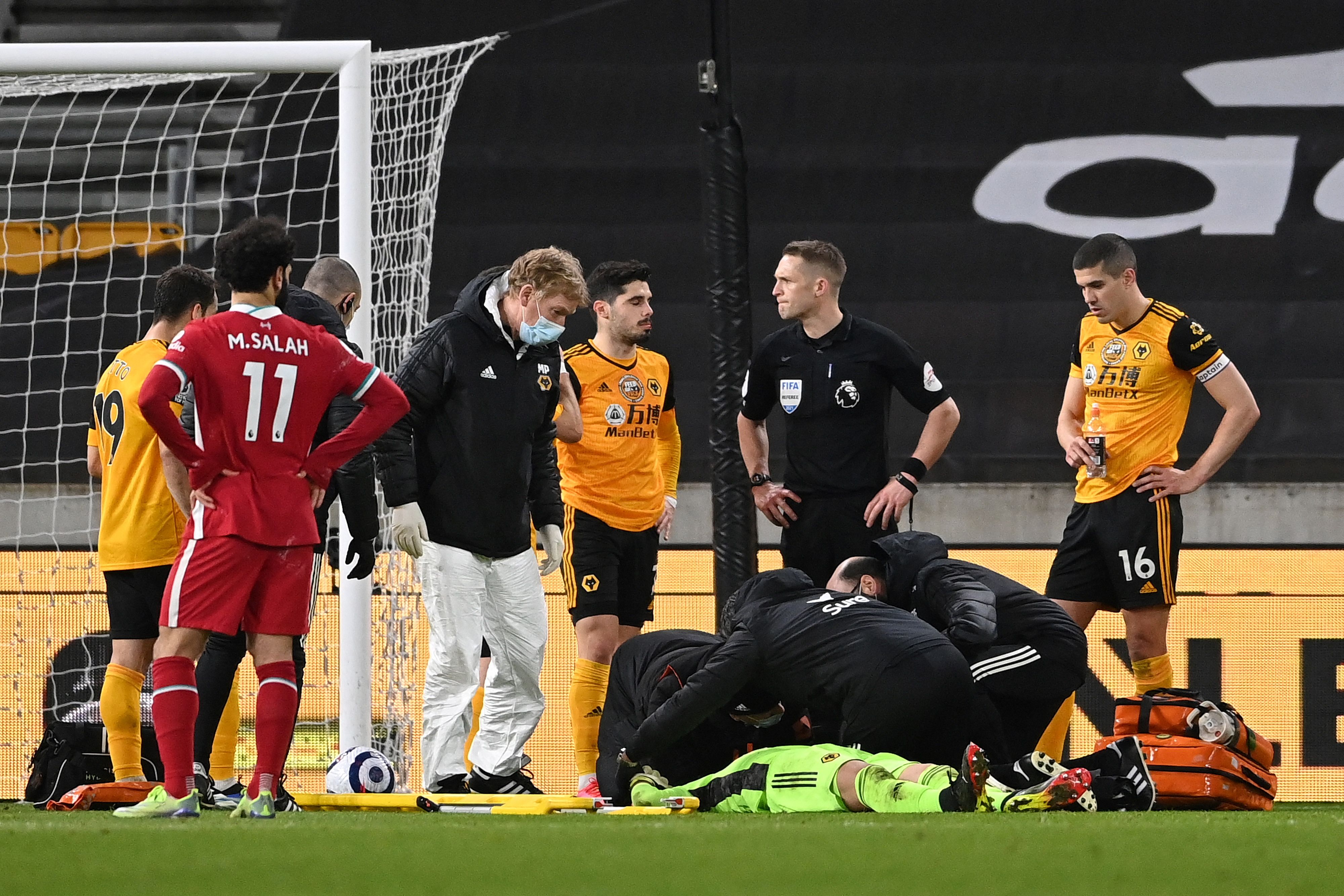 Conor Coady watches on as Rui Patricio receives medical treatment