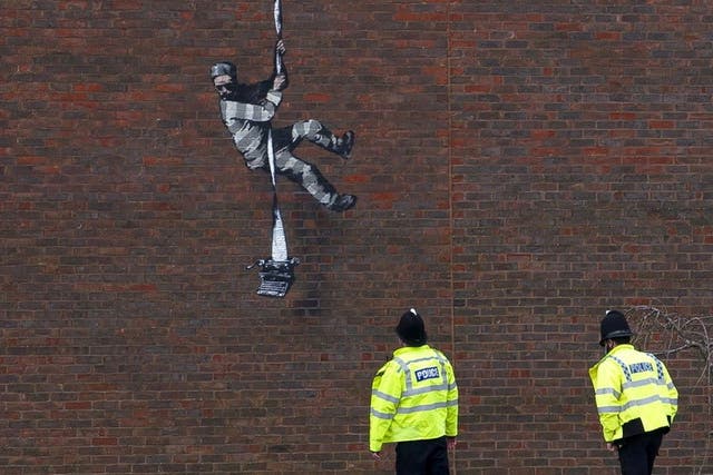 <p>File Image: Mural of artist Banksy on a wall at HM Reading Prison</p>