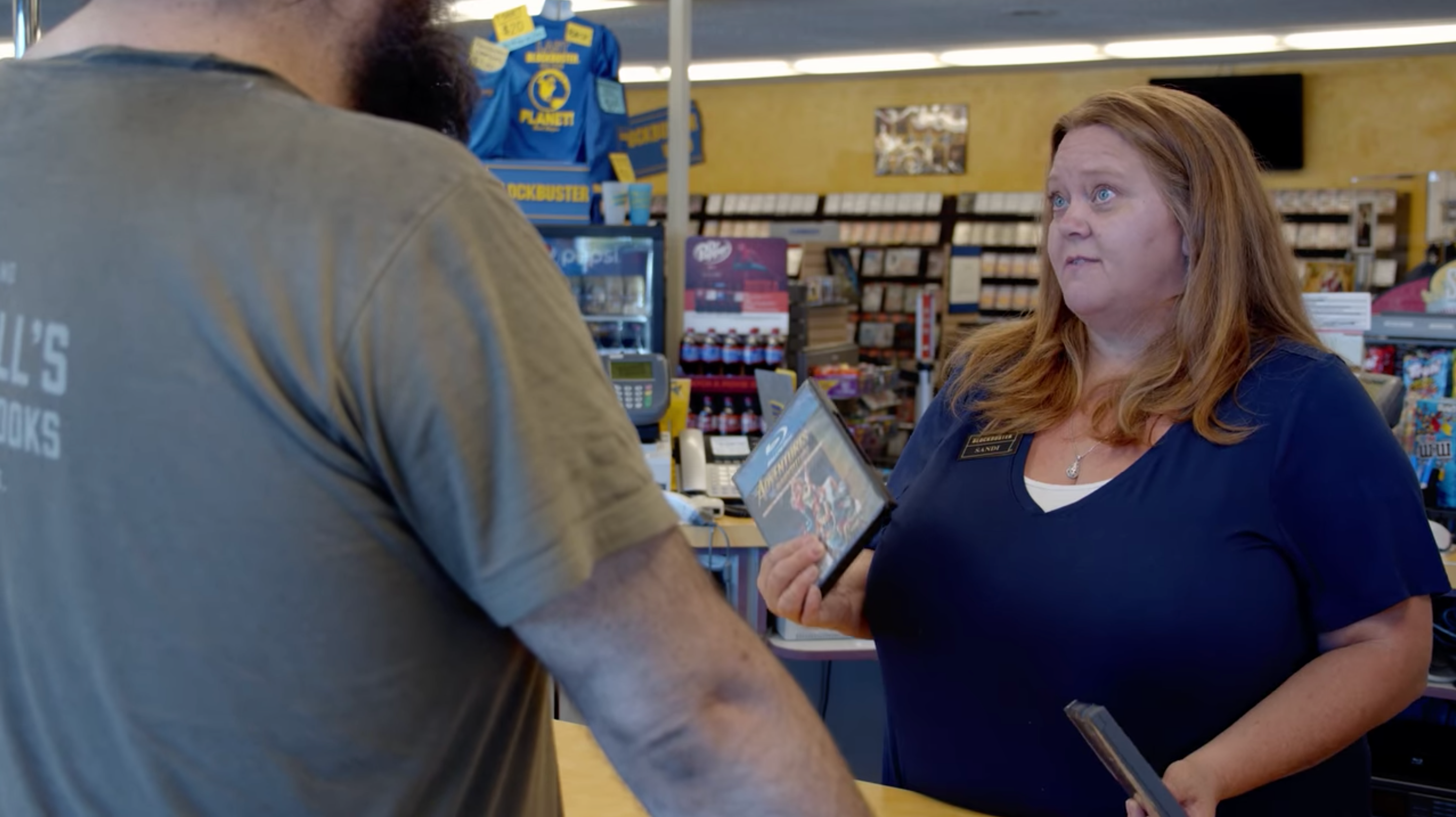 Sandi Harding helps a customer at the world’s last Blockbuster in Bend, Oregon