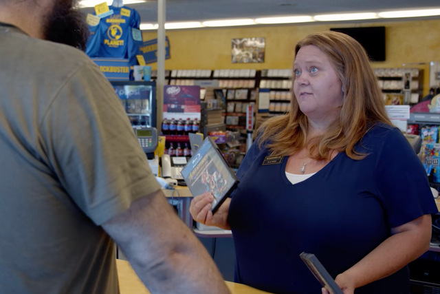 <p>Sandi Harding helps a customer at the world’s last Blockbuster in Bend, Oregon</p>