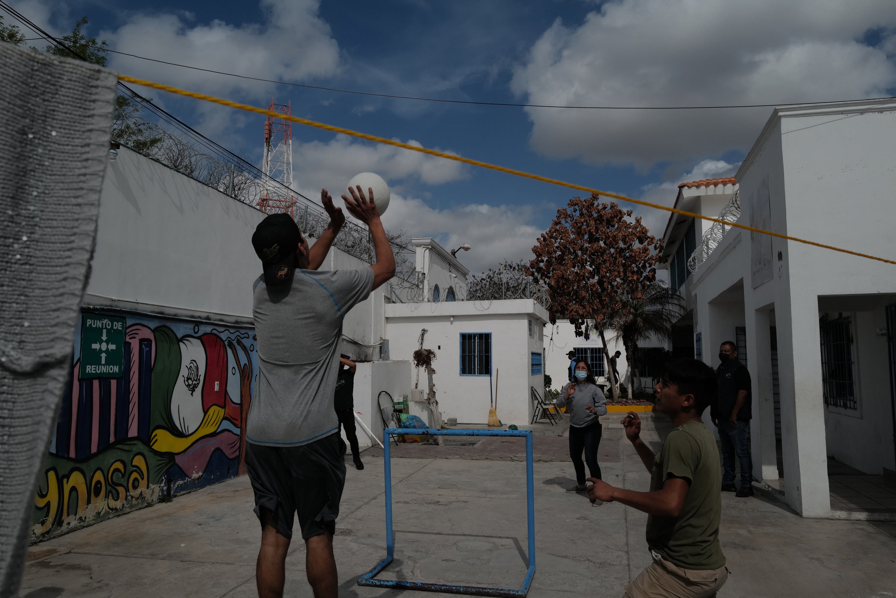 Children play volleyball during a break