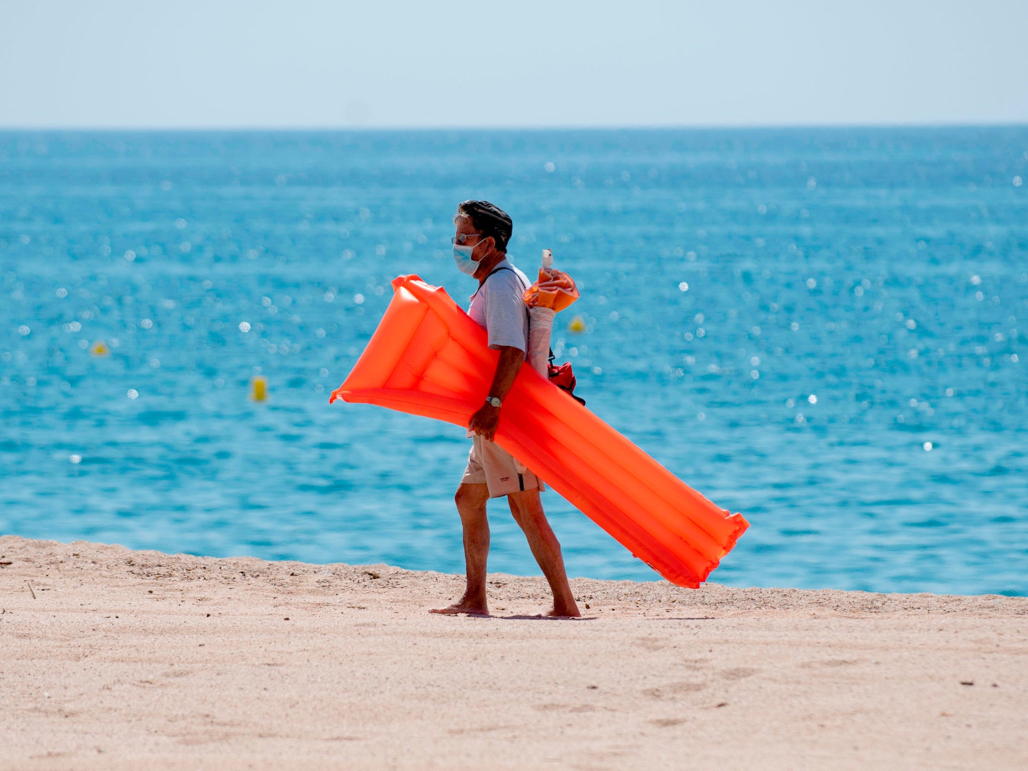 Holiday hotspots have welcomed the proposal (Pictured: A beachgoer in Spain’s Costa Brava last summer)