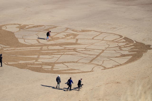 A giant 60-metre wide sand portrait of 12-year-old Ansha from Ethiopia created by WaterAid on Whitby Beach in Yorkshire. The image of the young girl, who spends hours each day collecting dirty water from a river, was created to illustrate how climate change threatens water access for world's poorest