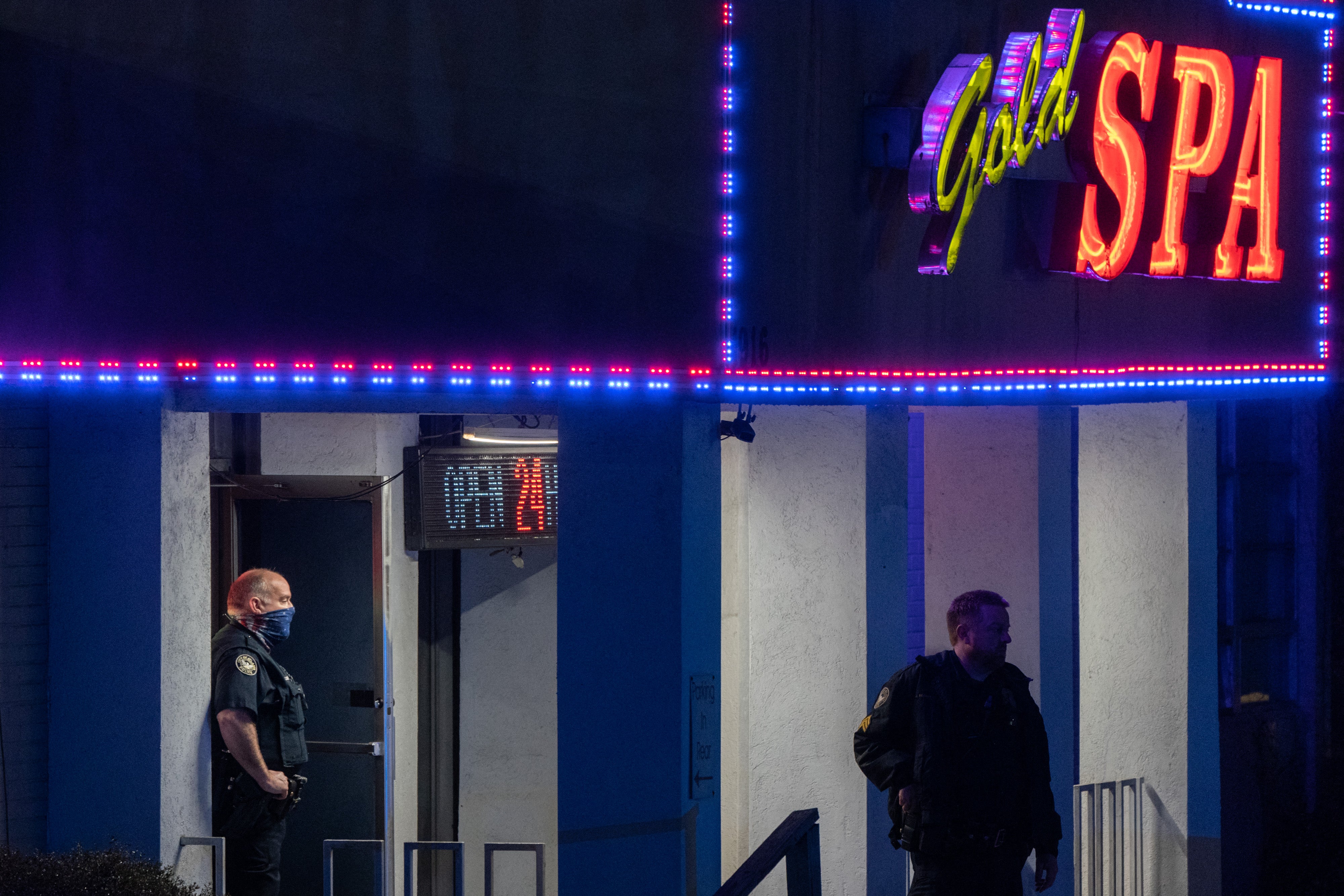 Police officers outside a massage parlour where three people were shot and killed on 16 March, 2021, in Atlanta, Georgia
