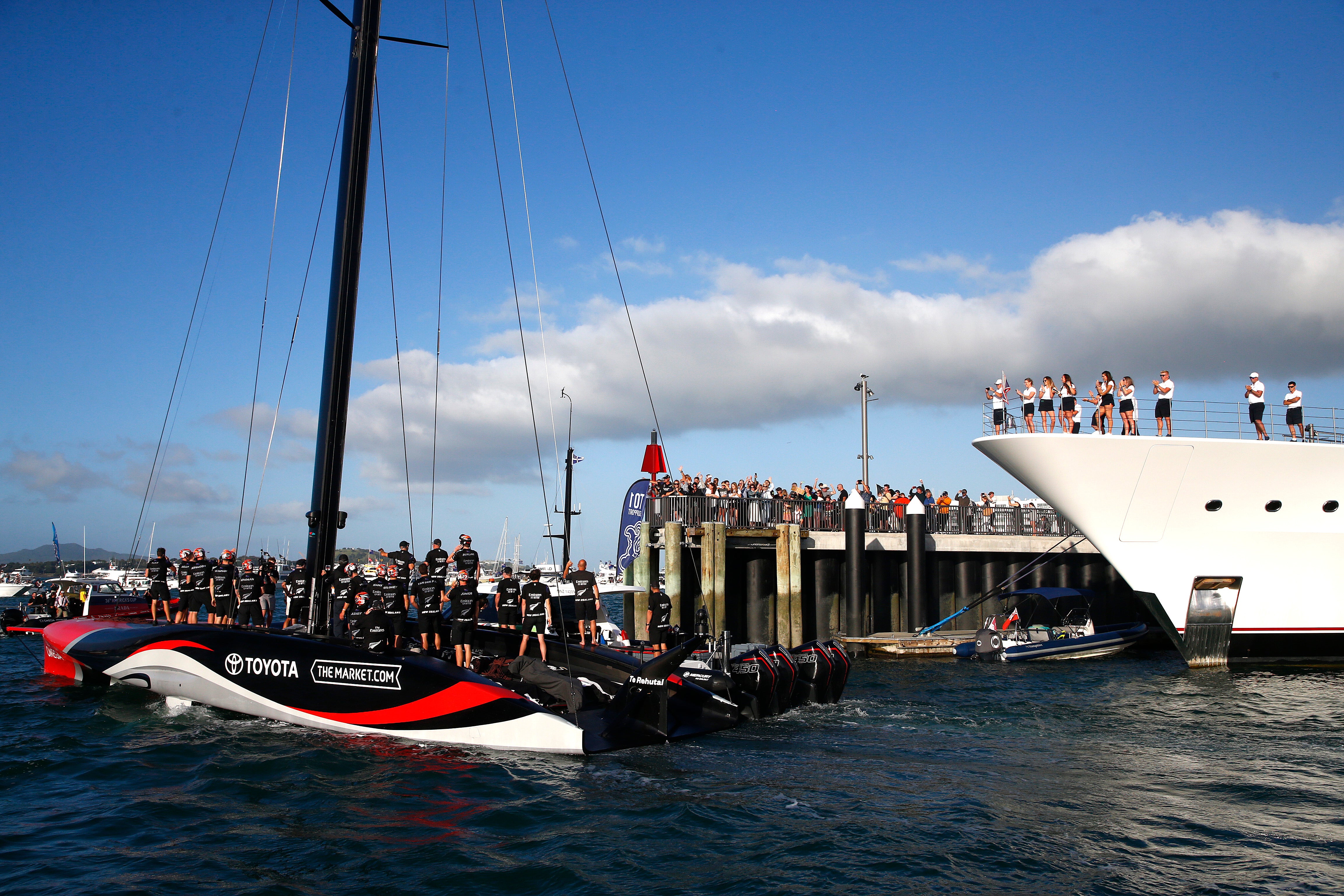 Team New Zealand do a lap around the Viaduct Harbour