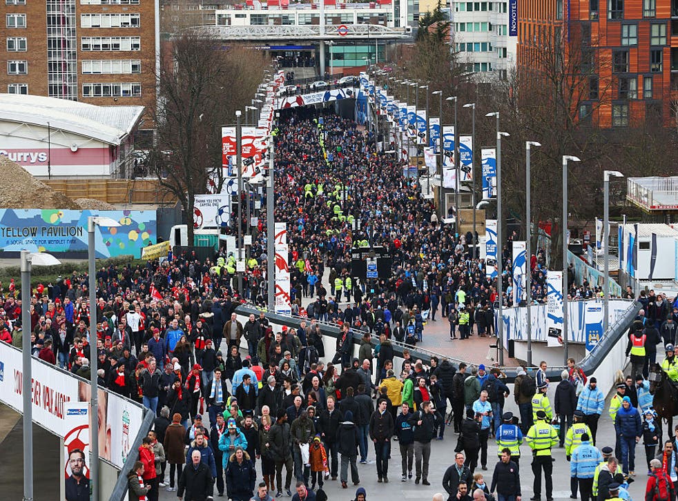 <p>Fans make their way to the League Cup final between Liverpool and Manchester City at Wembley Stadium on February 28, 2016</p>