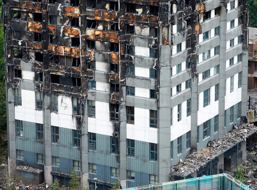 Remains of the tower’s unburned lower floors, with untouched cladding still in place, are pictured on 22 June 2017 – eight days after the fire