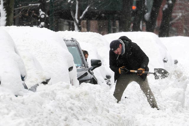 <p>A man helps a driver dig her car out from deep snow on Manhattan’s upper west side after a winter storm in New York City, New York, US, 2 February, 2021</p>