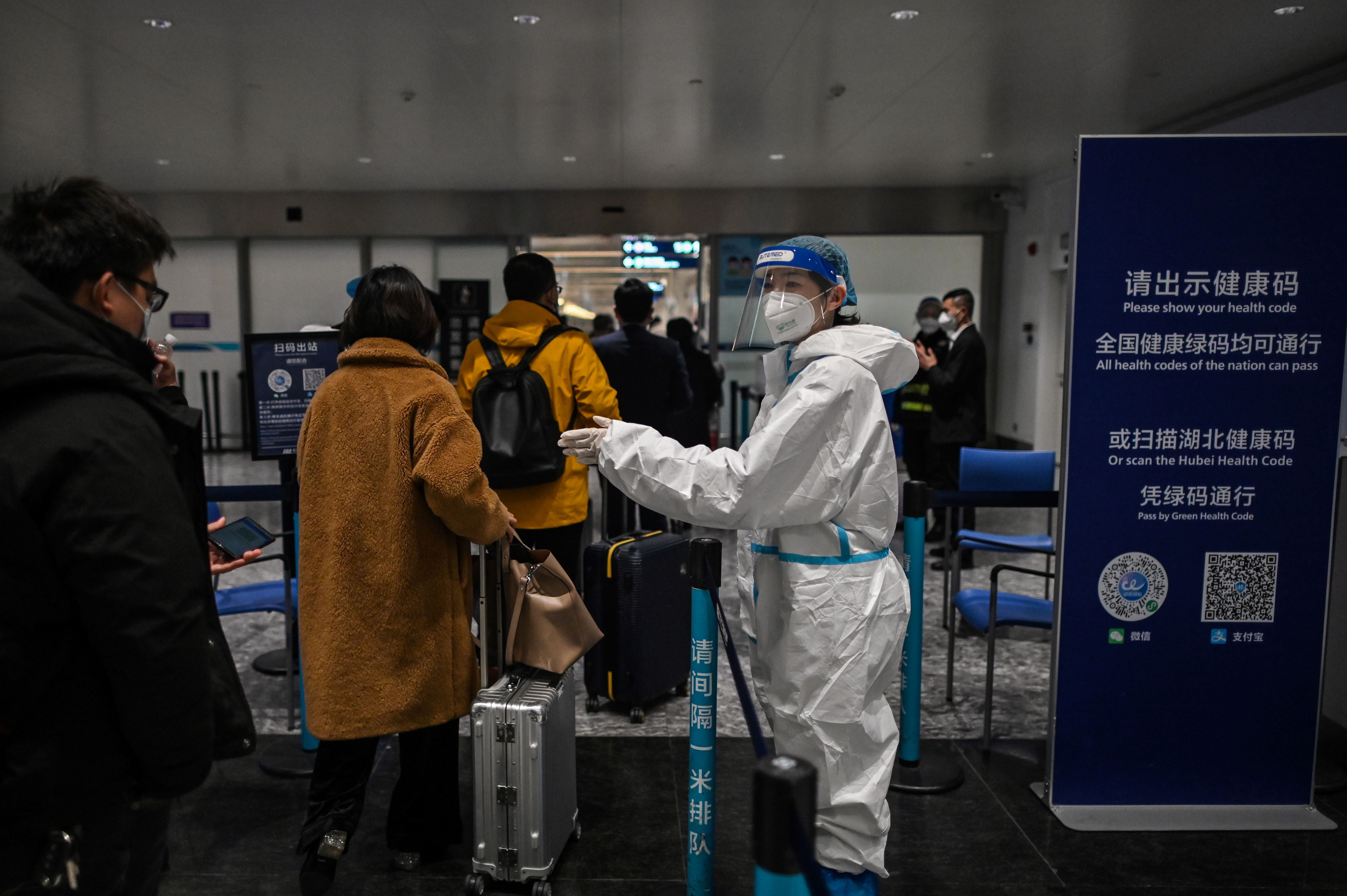 Passengers get their health code checked at the Tianhe International Airport in Wuhan