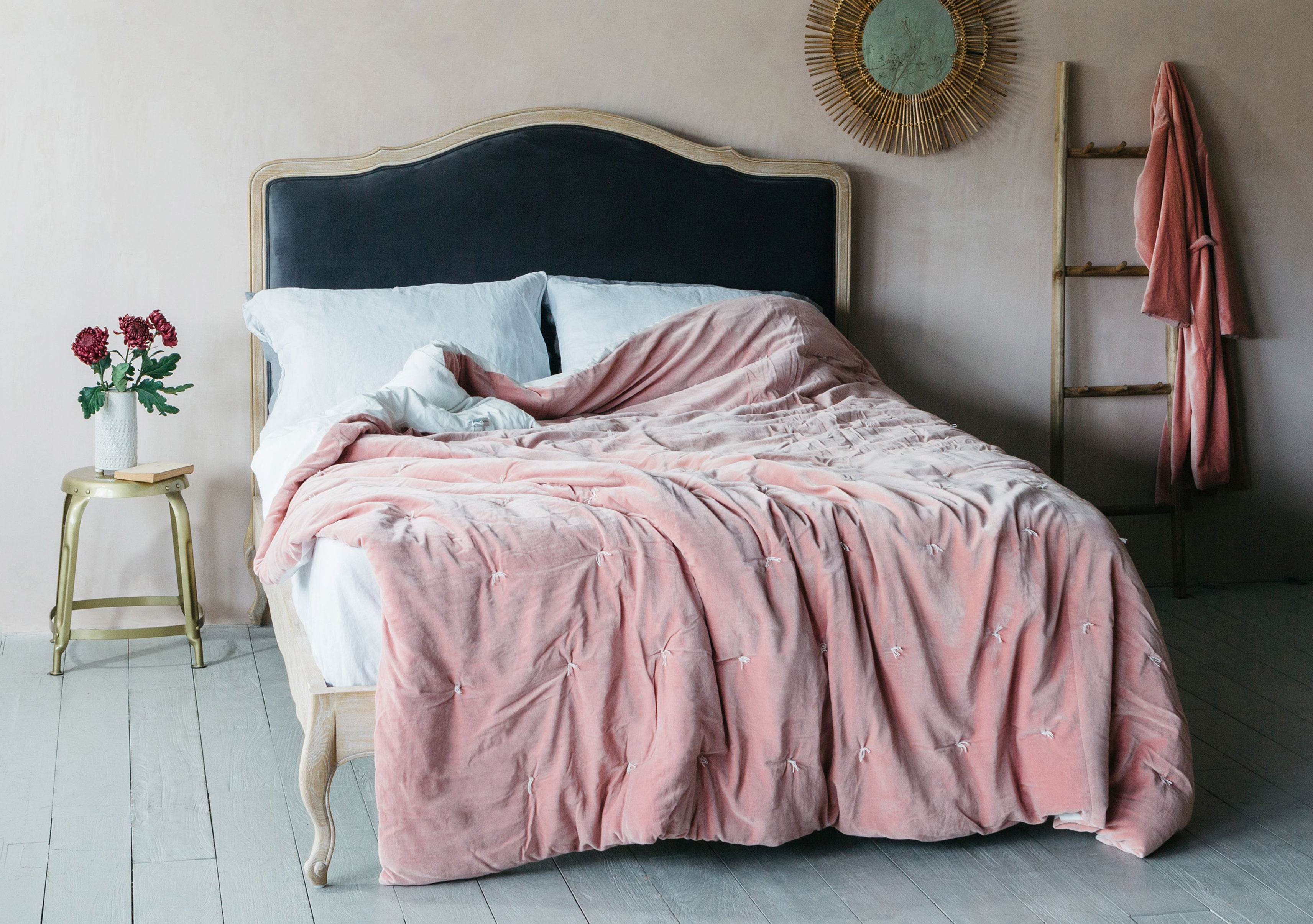 A bedroom featuring an Alora Grey Velvet Bed and Pebble Velvet King Size Quilt in Rose, from Graham & Green