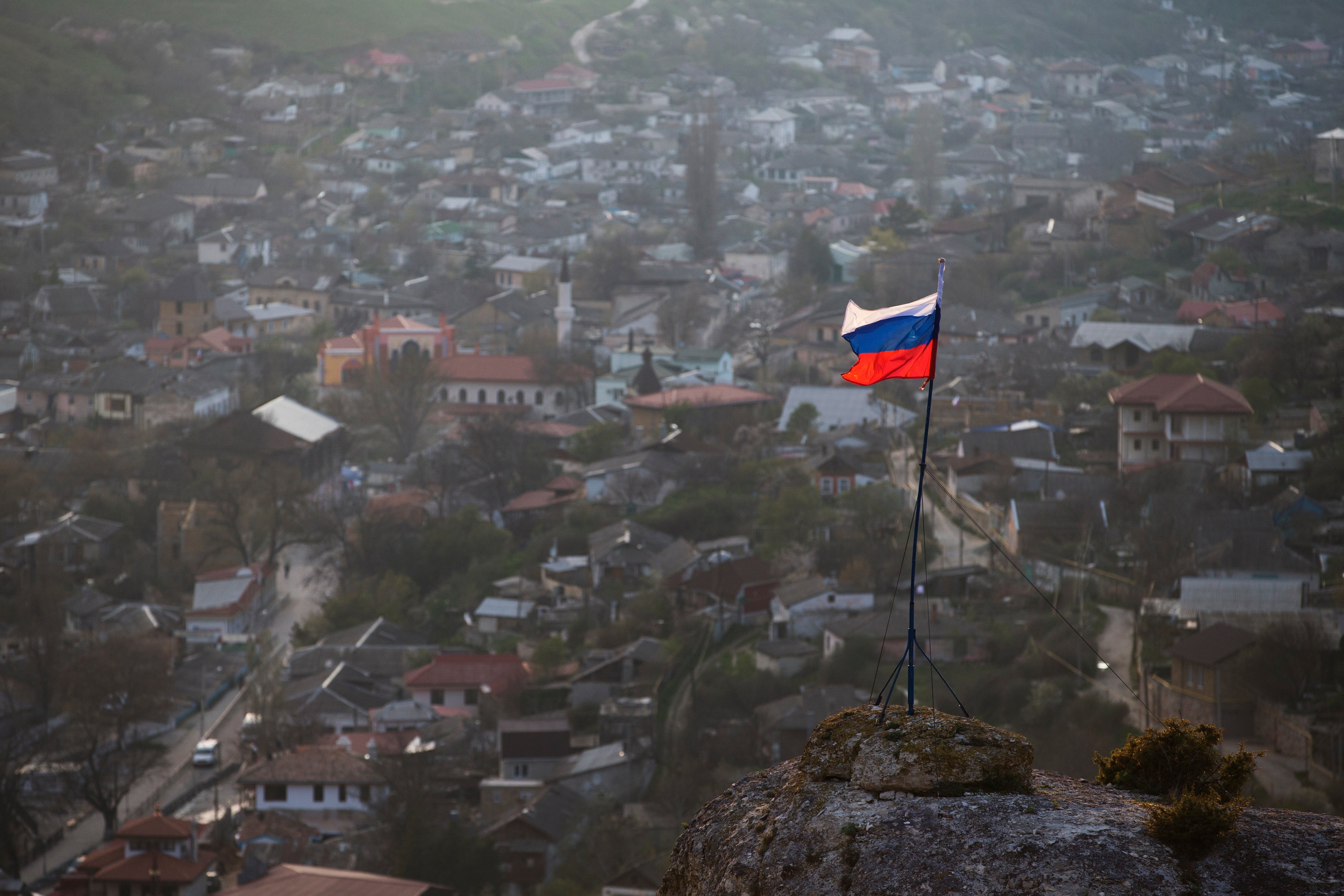 In this March 28, 2014 file photo, a Russian national flag flies on a hilltop near the city of Bakhchysarai, Crimea. The Group of Seven major industrialized countries on Thursday March 18, 2021, issued a strong condemnation of what it called Russia's ongoing “occupation” of the Crimean Peninsula, seven years after Moscow annexed it from Ukraine.