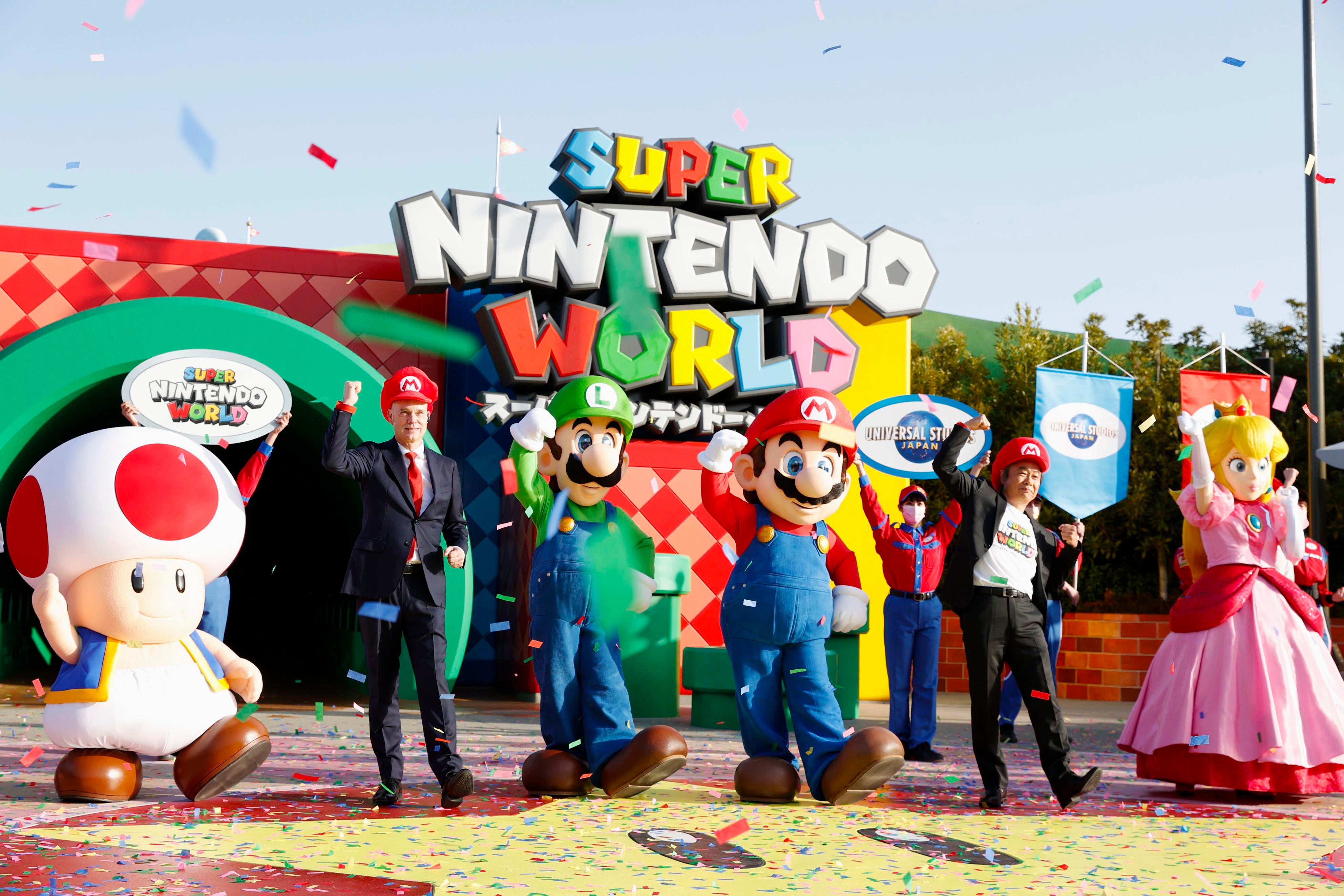 Mario, centre, and other characters participate in the opening ceremony of “Super Nintendo World,” the new attraction based on Nintendo Co.’s “Super Mario Bros”