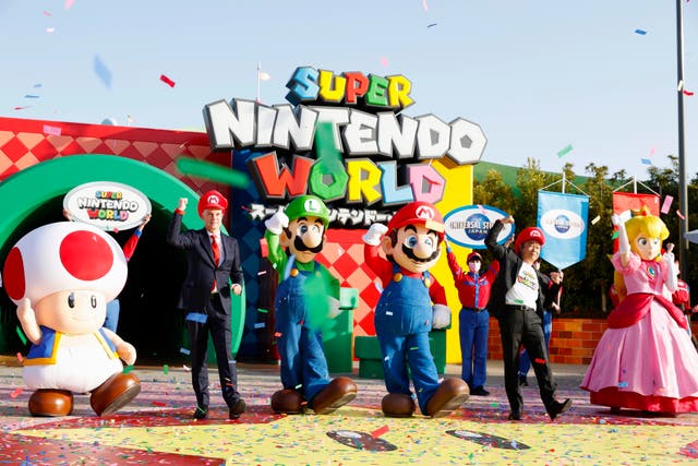<p>Mario, centre, and other characters participate in the opening ceremony of “Super Nintendo World,” the new attraction based on Nintendo Co.’s “Super Mario Bros”</p>