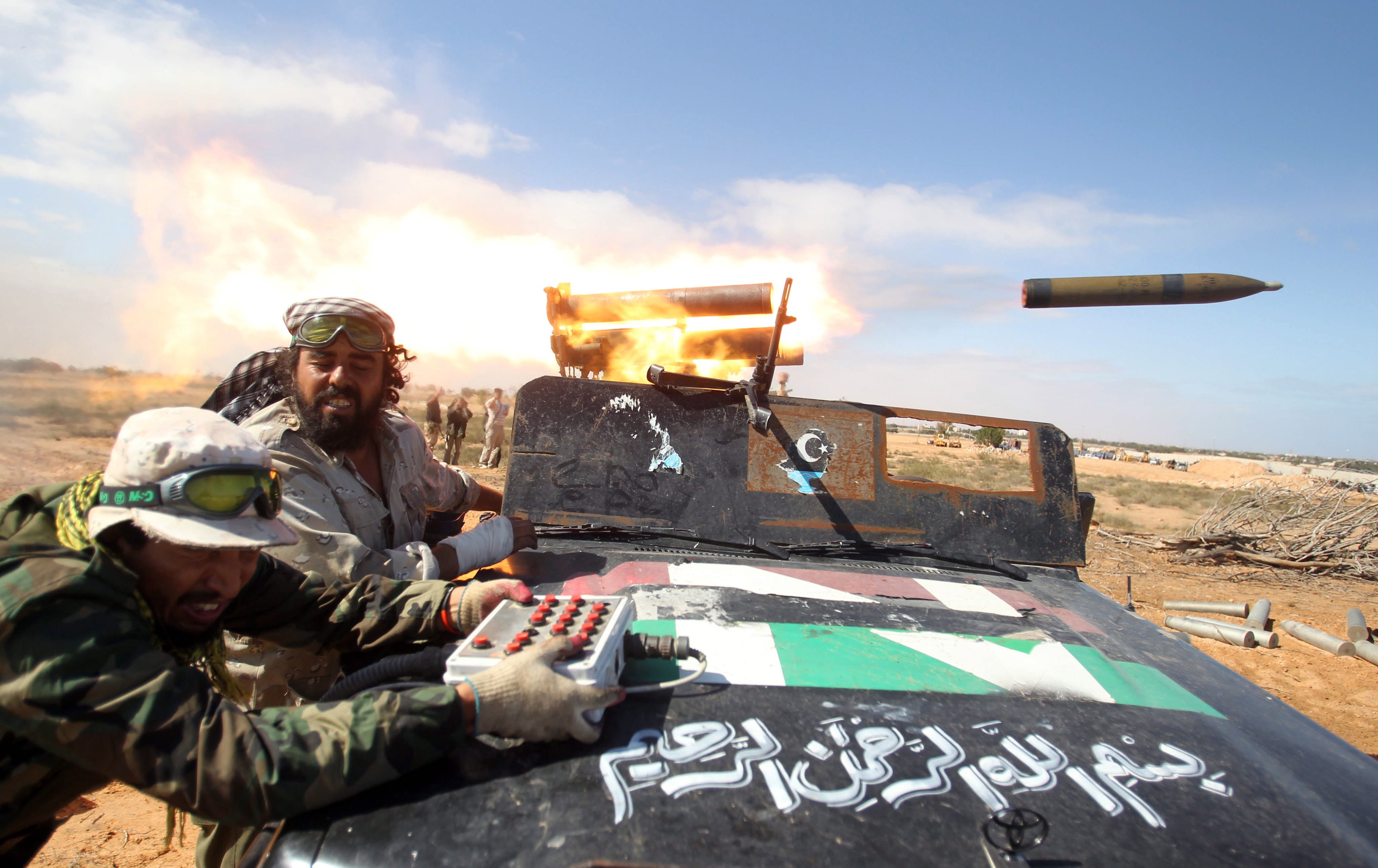 Libyan rebels fire a rocket as they enter the northern city of Sirte, 10 October 2011