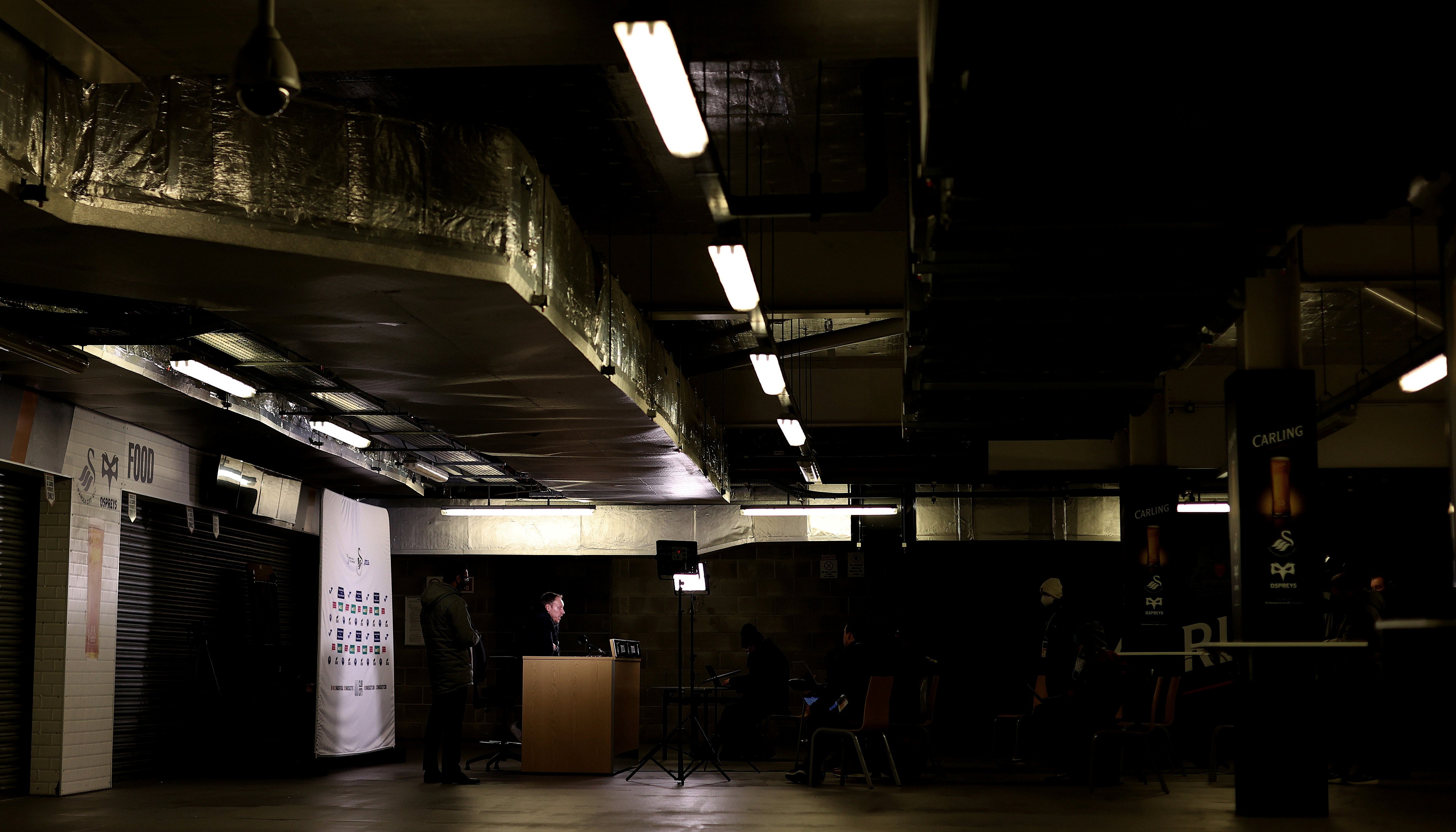 Swansea City manager Steve Cooper holds a press conference in a concourse underneath the main stand at Liberty Stadium in January. Interviews and press conferences have been moved from often very small press rooms to help with social distancing