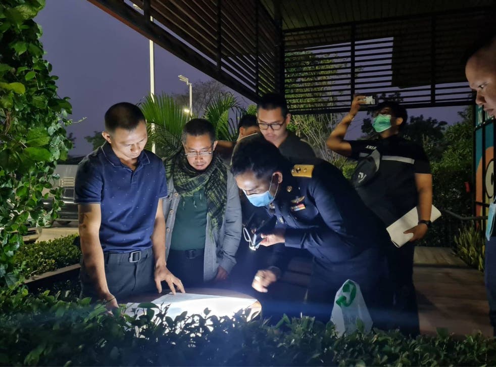 Thai authorities look at documents found during the operation against the syndicate