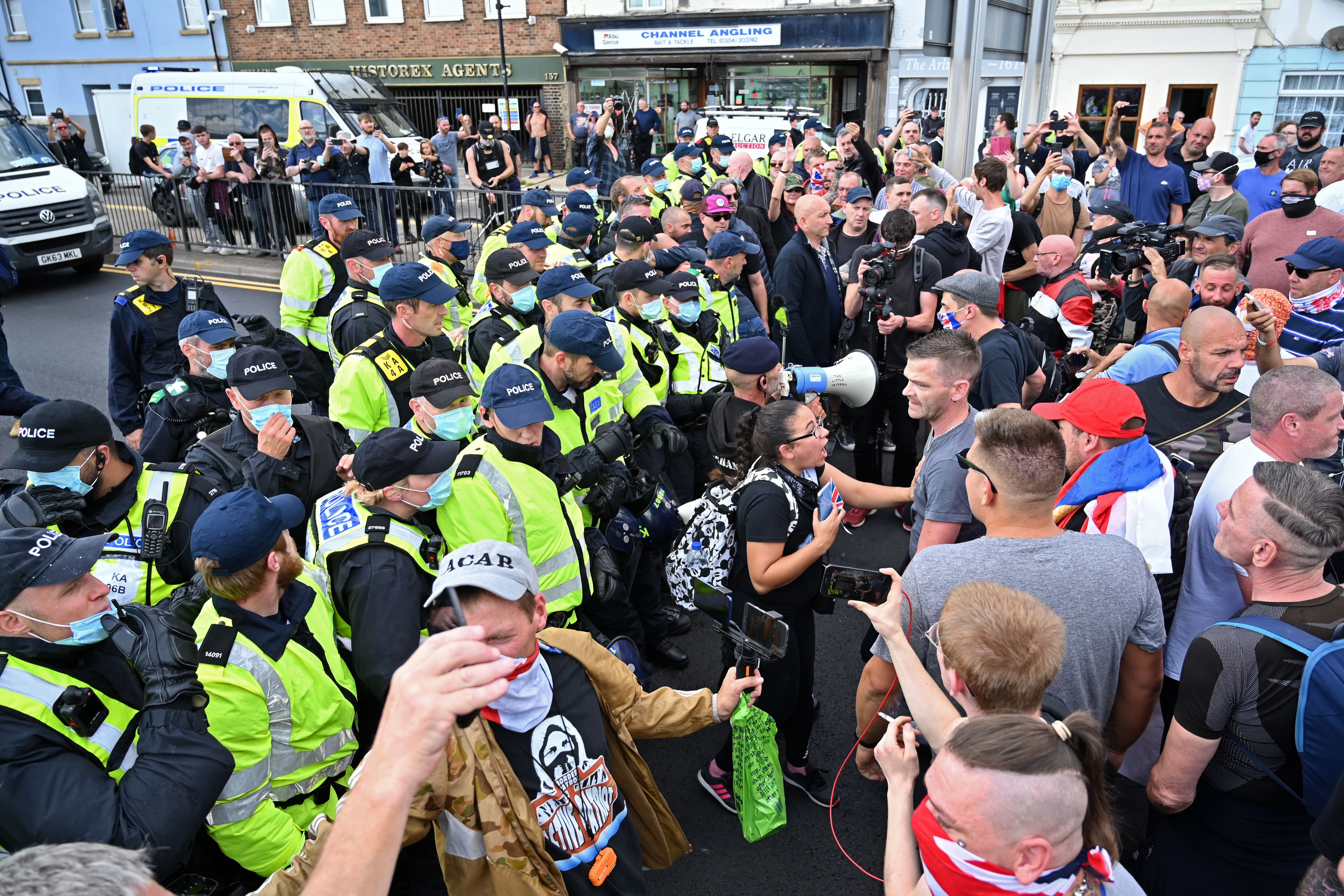 Police confront anti-immigration protesters on a main road in Dover