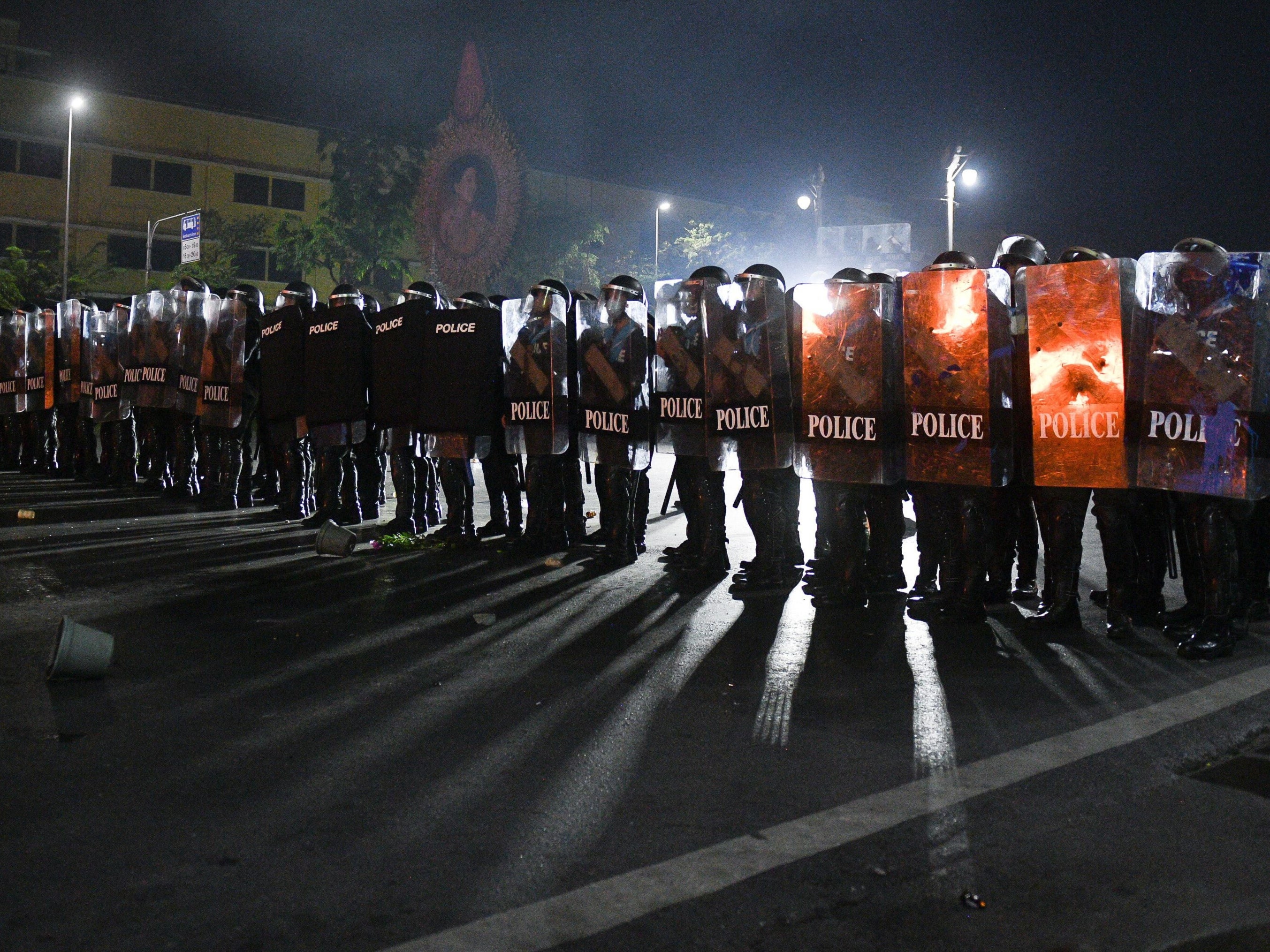 Riot police stand guard in central Bangkok during protests