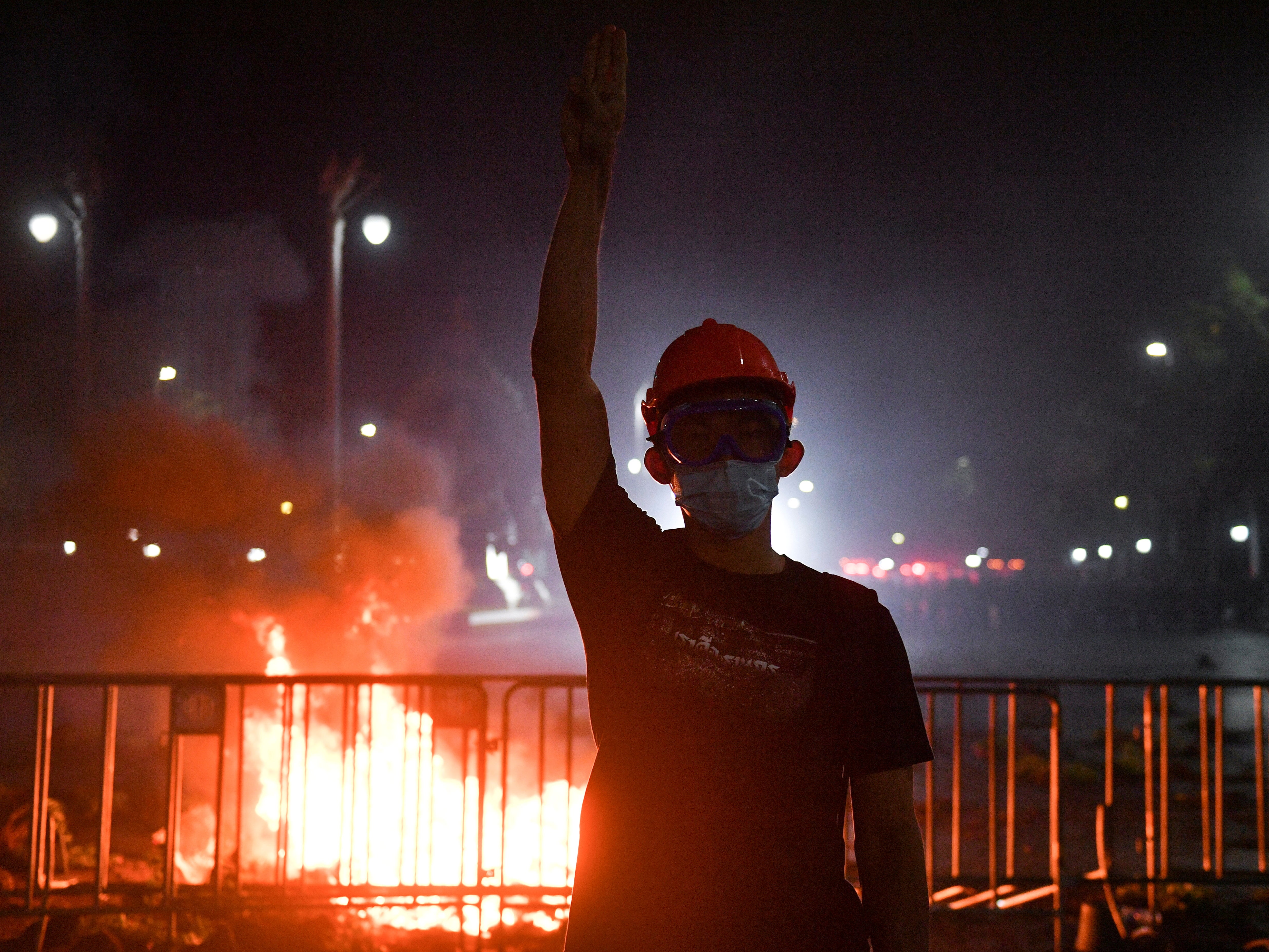 A demonstrator shows a three-fingers salute during an anti-government protest in Bangkok