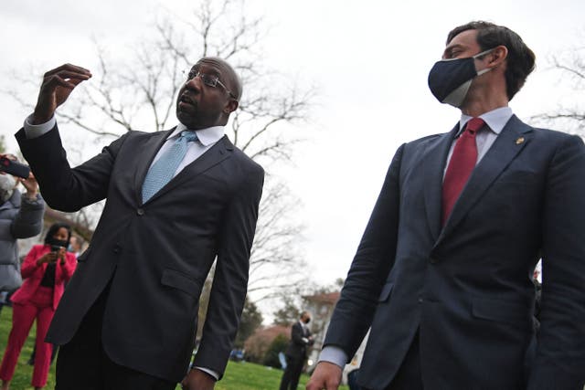 Senators Raphael Warnock, left, and Jon Ossoff spoke to college students in Atlanta as Joe Biden and Kamala Harris visited the city in the wake of a mass shooting there.