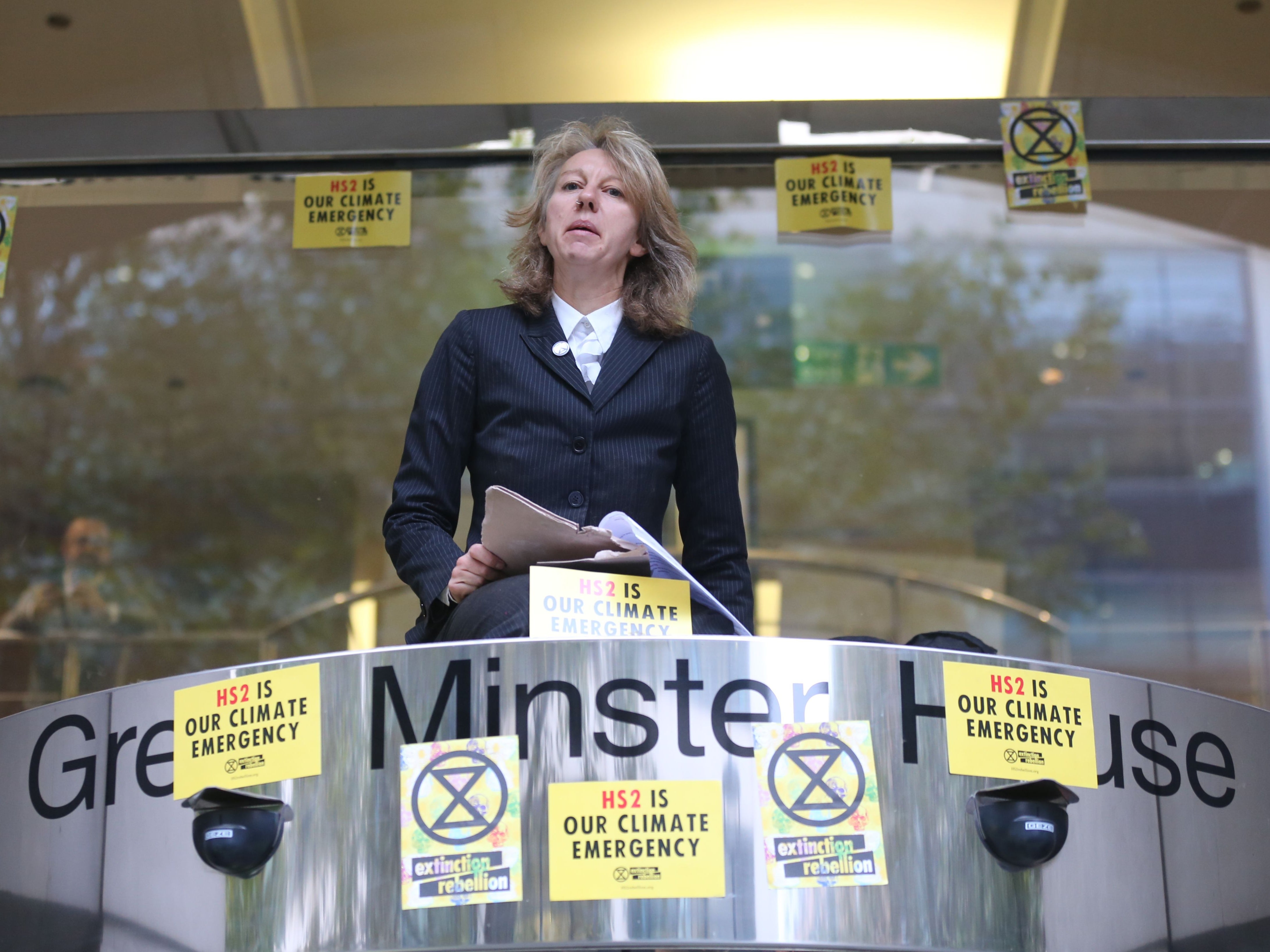 Gail Bradbrook speaks before smashing a window at the building housing the Department for Transport in protest against HS2 on 15 October 2019