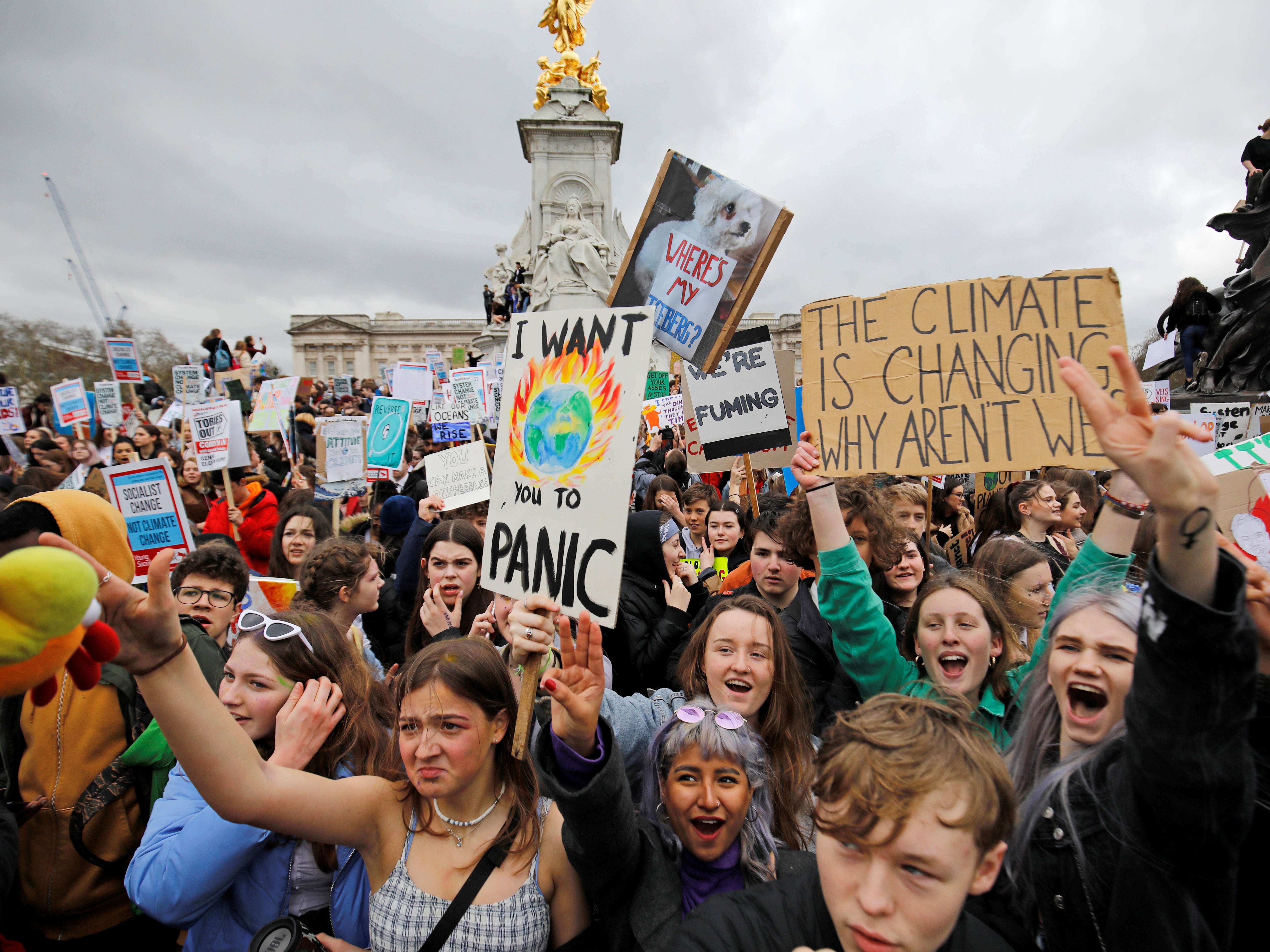 Young demonstrators protest around outside of Buckingham Palace during a climate strike on 15 March 2019