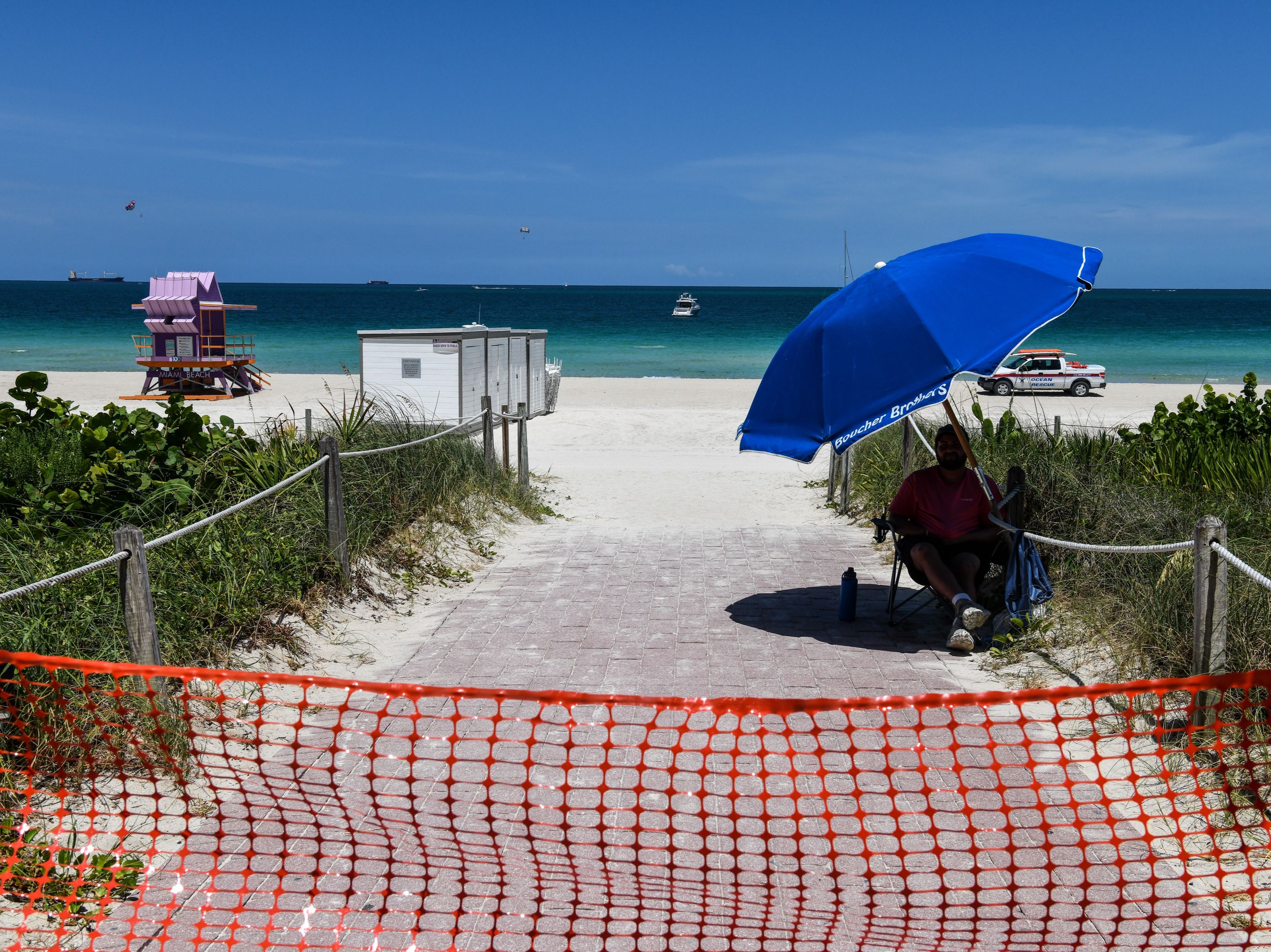 An ocean rescue staff guards the closed beach ahead of the July 4th holiday weekend in Miami Beach, Miami, on 3 July 2020