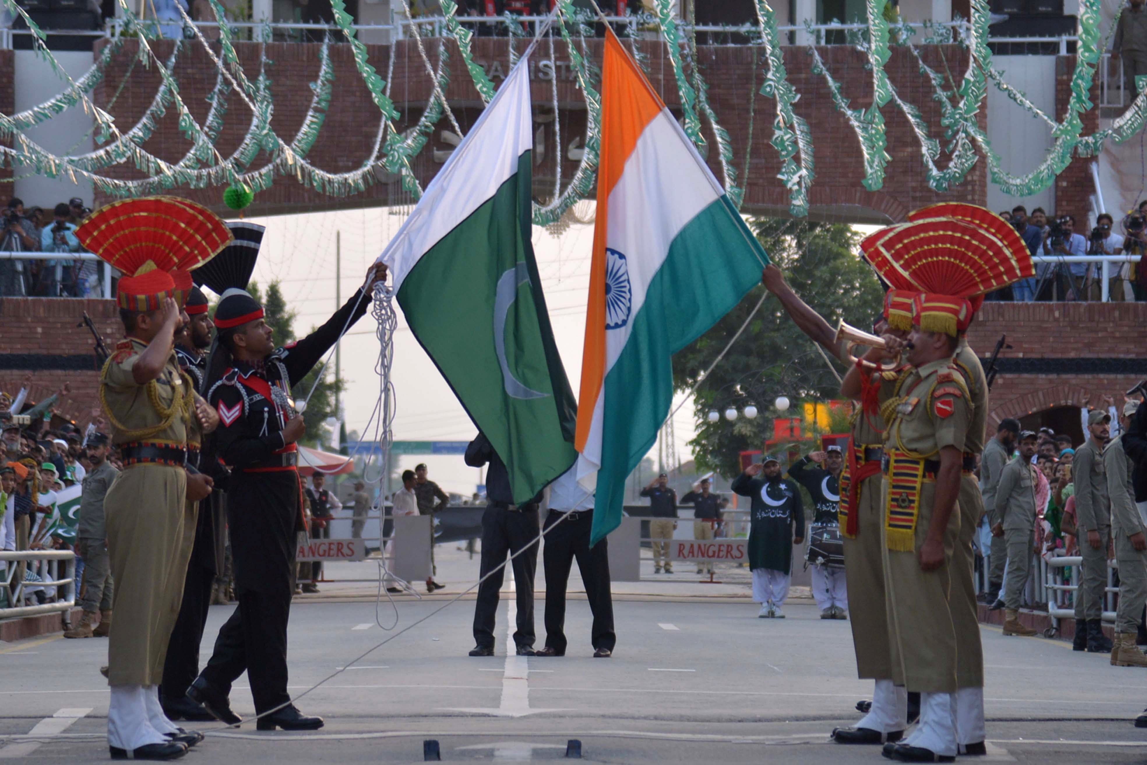 File: Indian Border Security Force personnel and Pakistani Rangers perform flag ceremony at India-Pakistan Wagah border