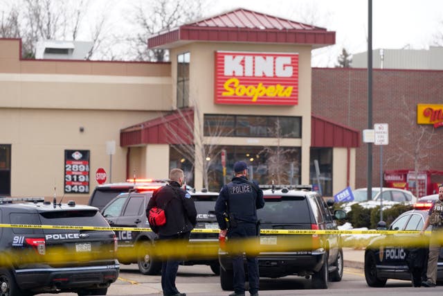 <p>Police stand outside the King Soopers grocery store where the shooting took place</p>