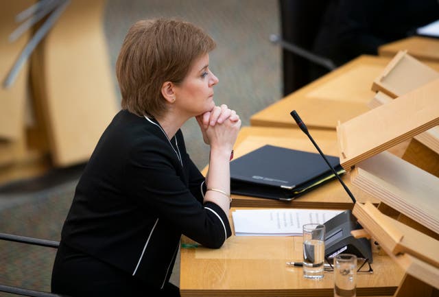 <p>Scotland’s first minister Nicola Sturgeon in the main chamber ahead of a Covid briefing in Holyrood, on 23 March</p>
