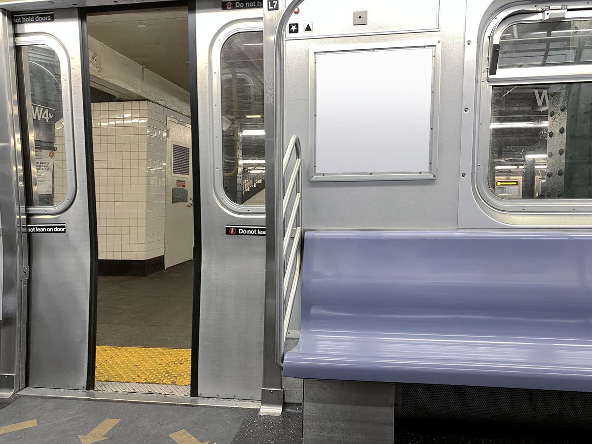 Man attacks Asian American woman on New York subway as other passengers look on