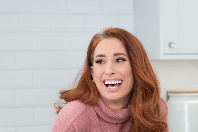 Stacey Solomon in a pink jumper at home, laughing and happy