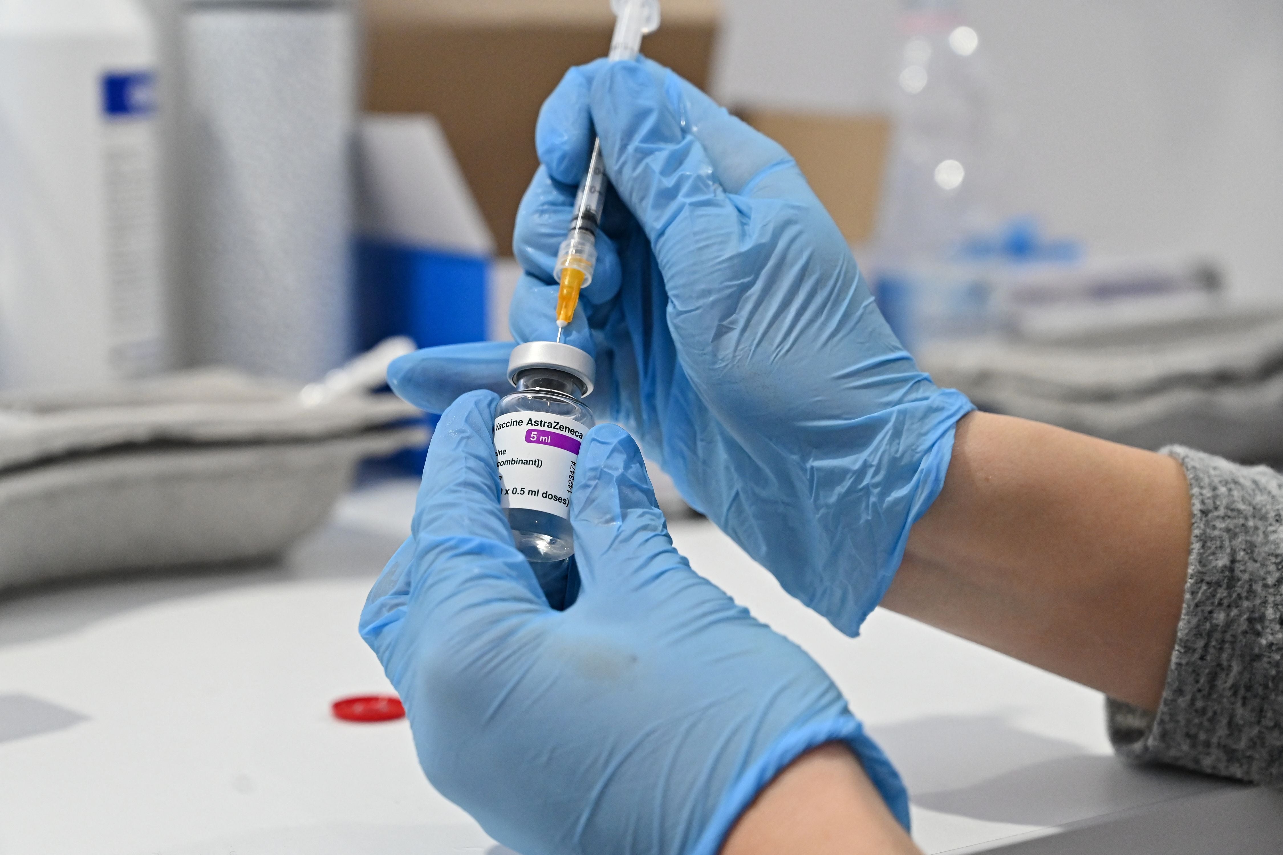 A medical worker fills a syringe from a vial of the AstraZeneca vaccine against Covid-19 on March 24, 2021 at a vaccination hub outside Rome's Termini railway station