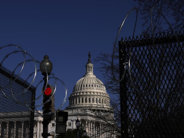 Razor wire is attached to the top of temporary fencing as the U.S. Capitol is seen in the background on March 4, 2021 on Capitol Hill. 