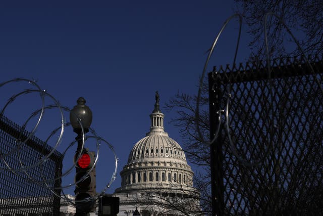 Razor wire is attached to the top of temporary fencing as the U.S. Capitol is seen in the background on March 4, 2021 on Capitol Hill. 