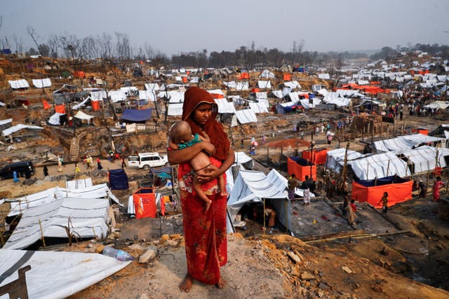 <p>A Rohingya woman with her child at a refugee camp</p>