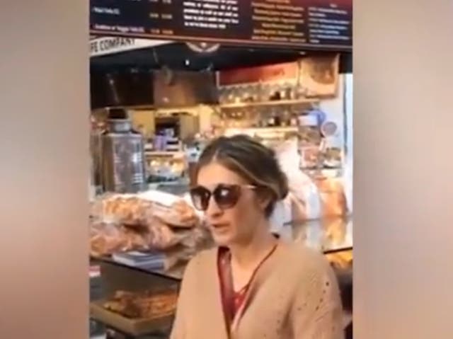 <p>The woman, who has not been identified, can be seen in the video arguing with an employee behind the counter after she was refused service due to not wearing a mask</p>