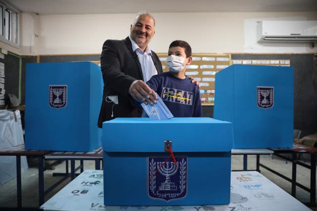 <p>Kingmaker in the making: Mansour Abbas, leader of the United Arab List, votes at a polling station in Maghar, Israel</p>