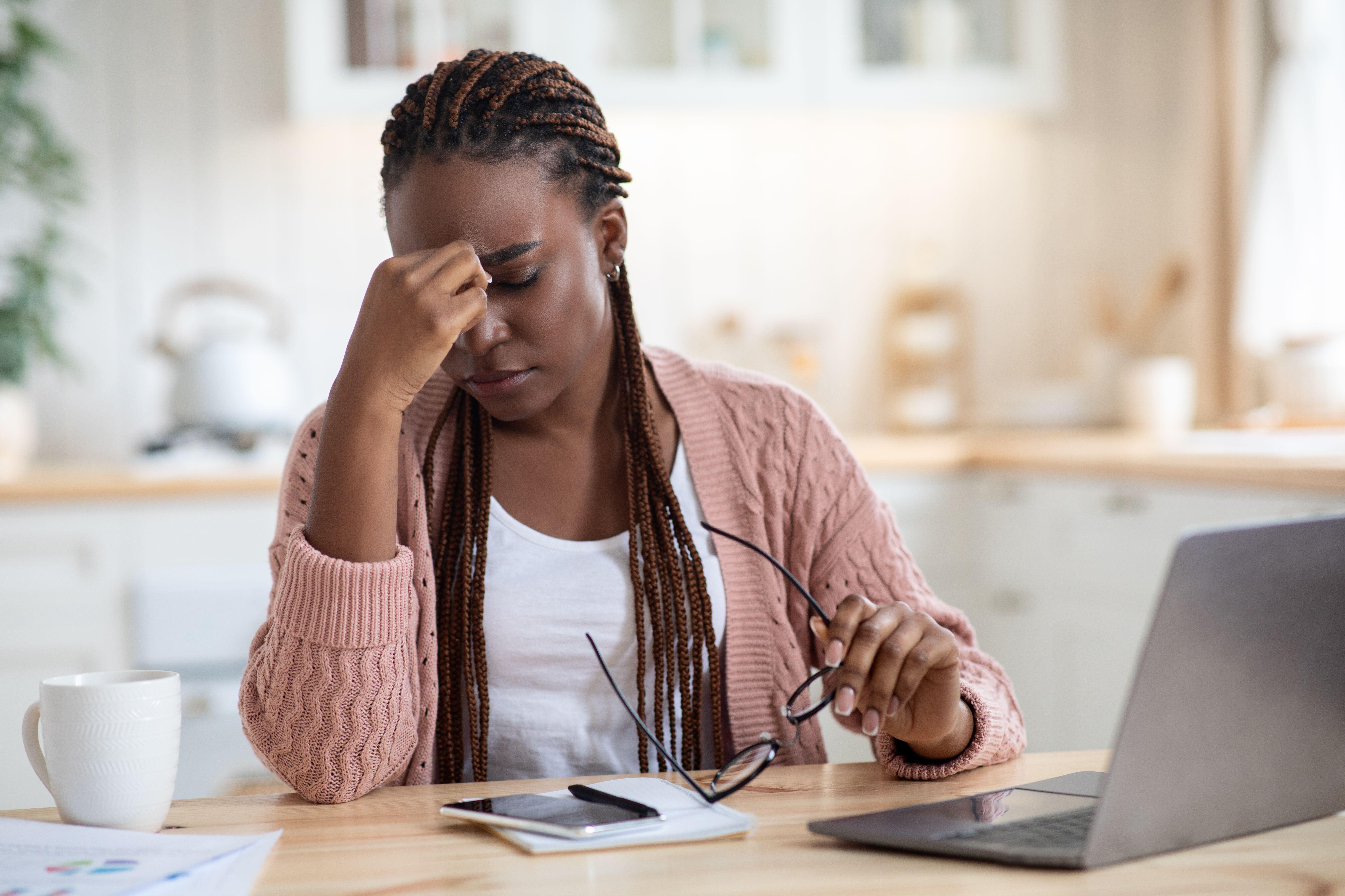 Woman working at home looking stressed