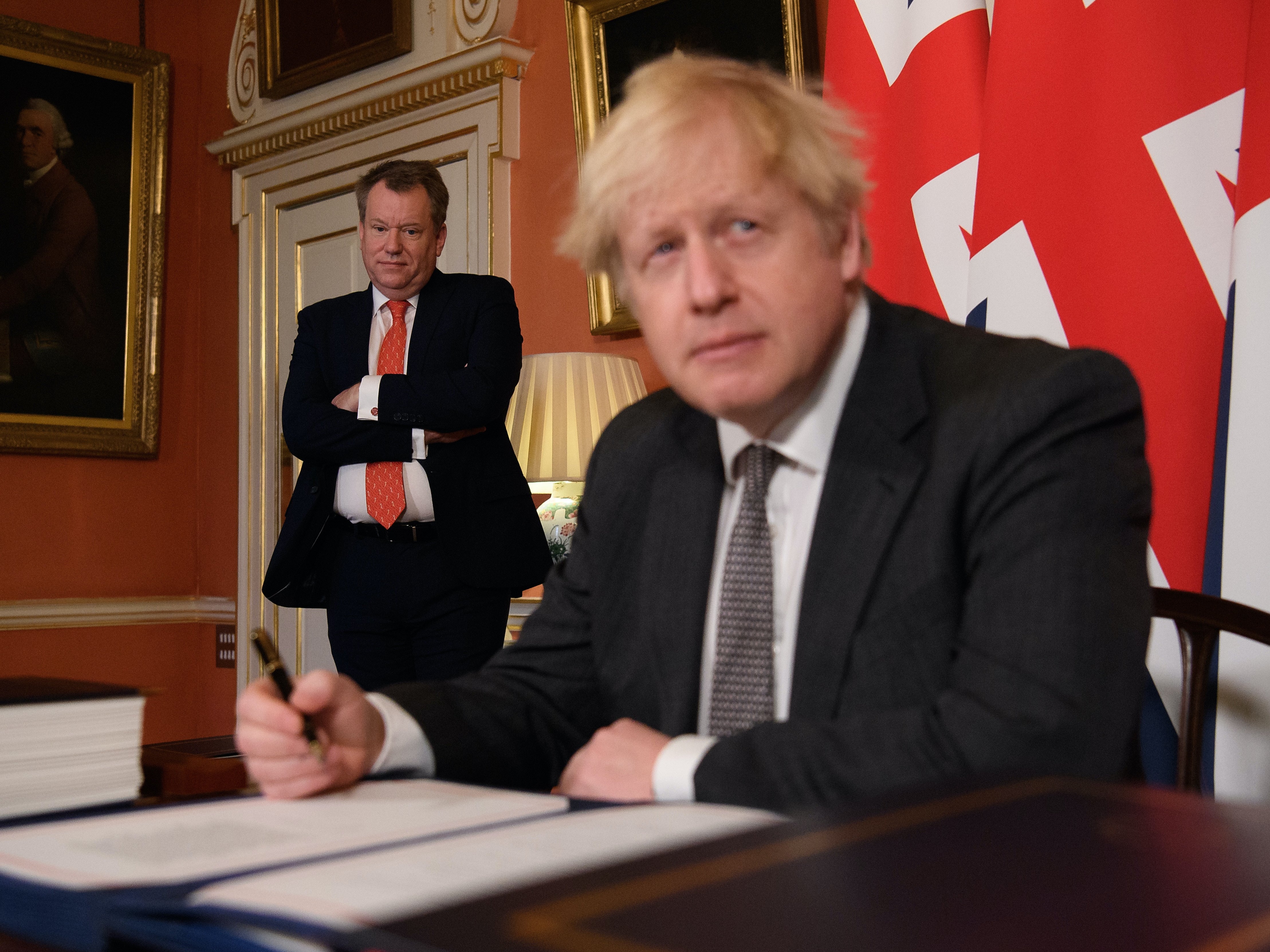 David Frost looks on as Boris Johnson signs Brexit trade deal