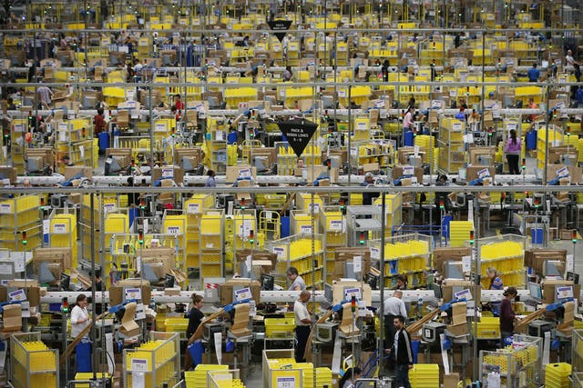 <p>Parcels are prepared for dispatch at Amazon’s warehouse in Hemel Hempstead in 2014</p>