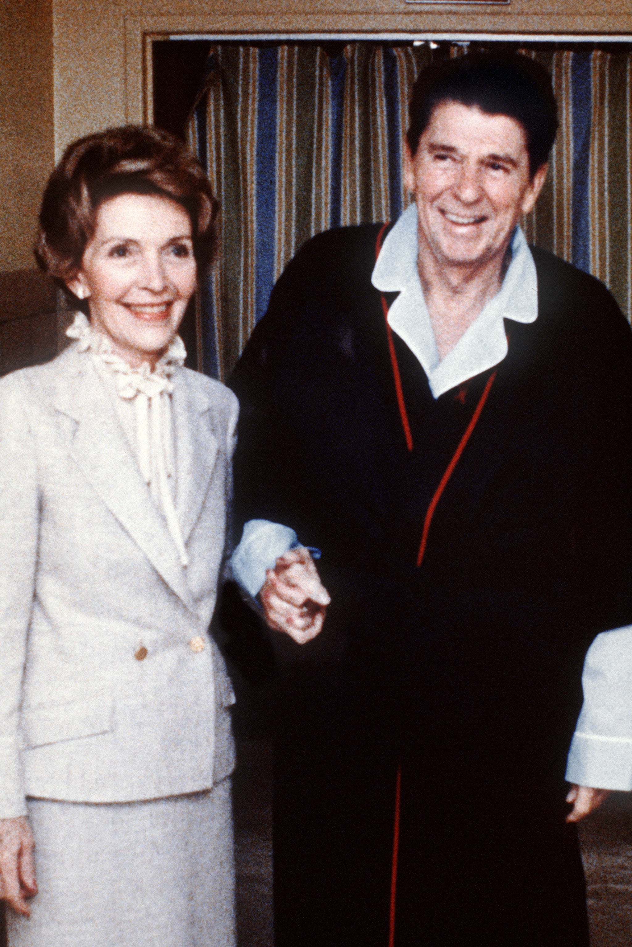 Ronald and Nancy holding hands at the George Washington University Hospital four days after the attempt on his life