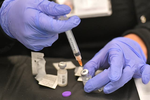 <p>A health worker prepares a dose of the Pfizer BioNTech vaccine at a Covid-19 vaccination site at the University of Nevada in Las Vegas on 15 March 2021</p>