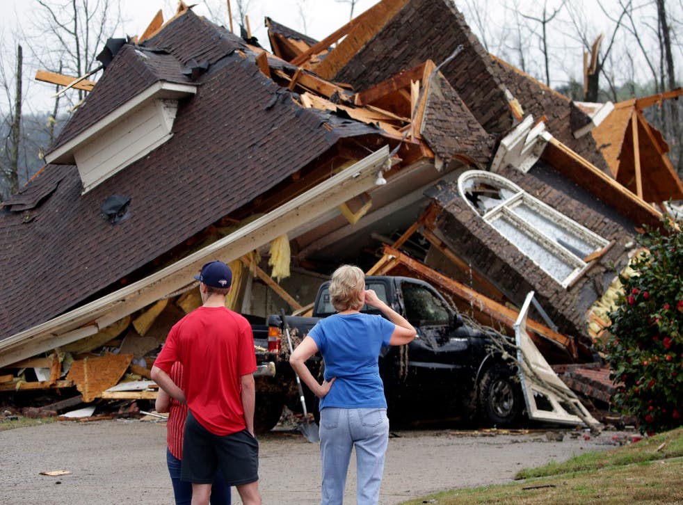 <p>Residents survey damage to homes after a tornado touches down south of Birmingham, Ala. in the Eagle Point community damaging multiple homes, Thursday, March 25, 2021</p>
