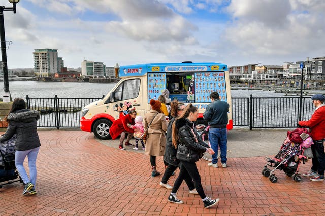 People queue for an ice-cream van in Cardiff Bay, Wales, where stay at home restrictions are eased and people are permitted to travel within their local area, including meeting family and friends who live locally as long as it is outdoors