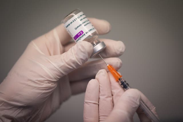 A pharmacist prepares a dose of the AstraZeneca Covid-19 vaccine with a syringe in a pharmacy in Nantes