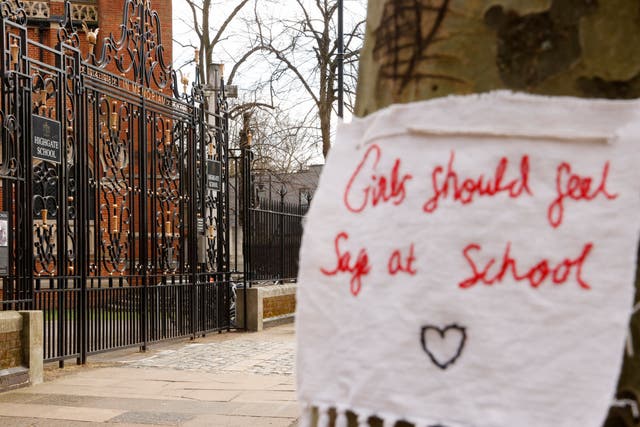 A sign saying ‘girls should feel safe at school’ hangs outside Highgate School, where pupils have also faced allegations