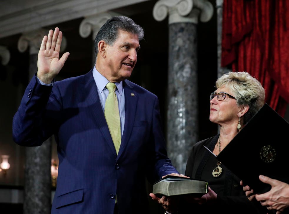 <p>Joe and Gayle Manchin, pictured as he is sworn into office in 2019</p>