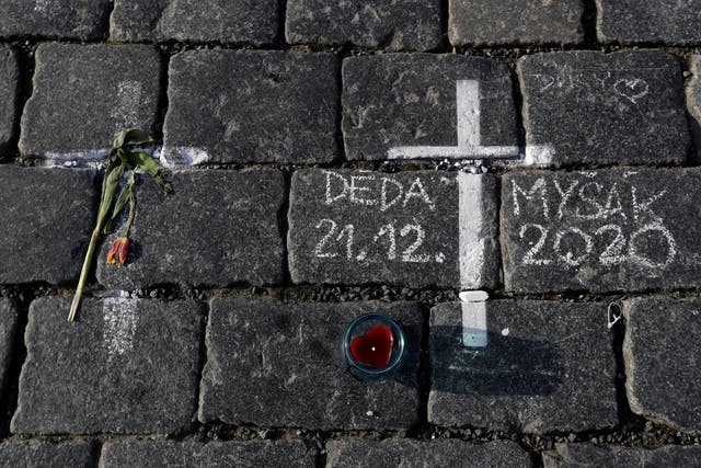 <p>Thousands of crosses have been painted on a pavement in Old Town Square to commemorate a year since the first Covid death</p>