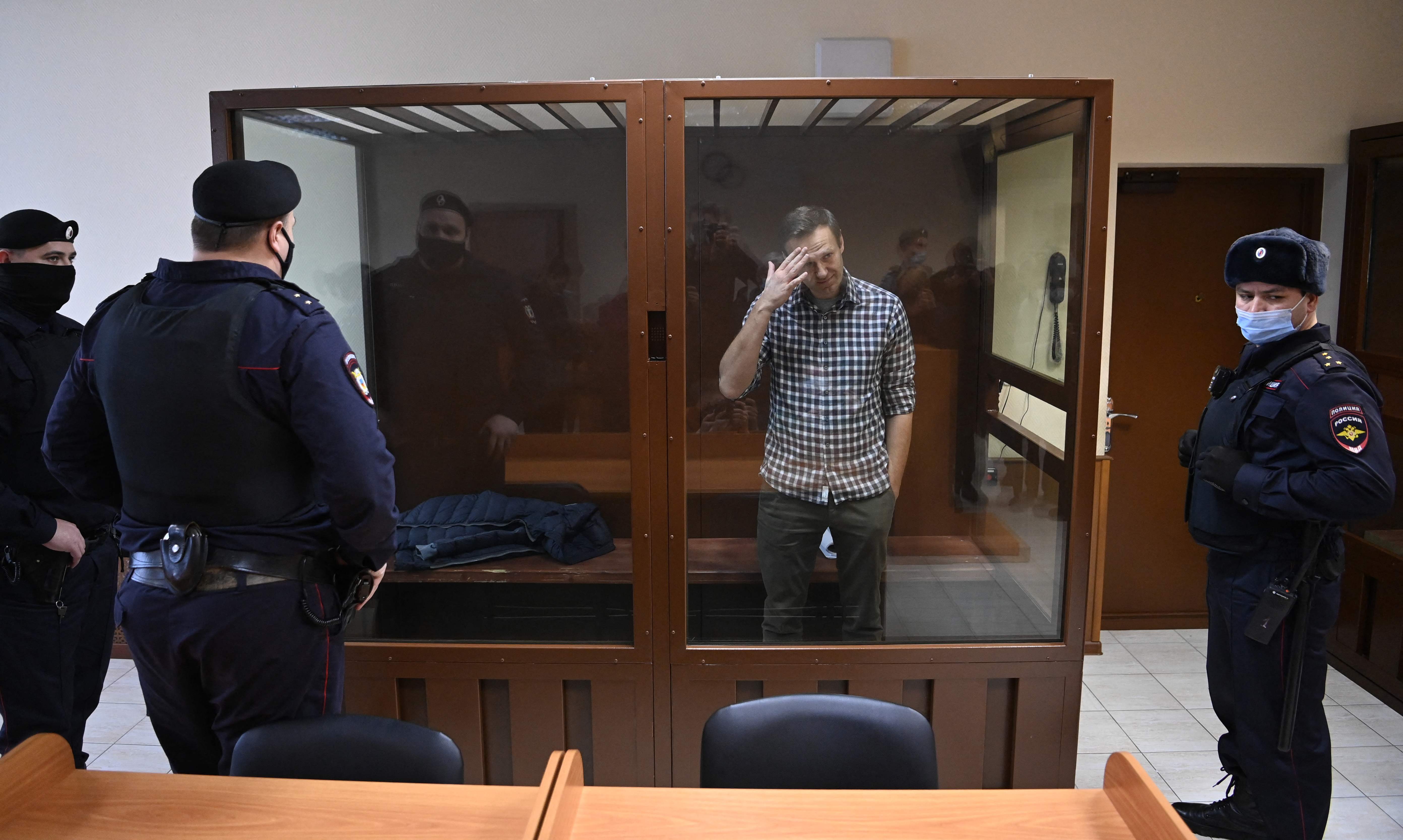The Russian opposition leader stands inside a glass cell during a court hearing at the Babushkinsky district court in Moscow in February